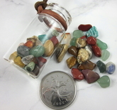 Polished gemstone chips in a corked bottle